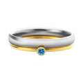 December birthstone geometric engraved ring in titanium steel on a grey background.