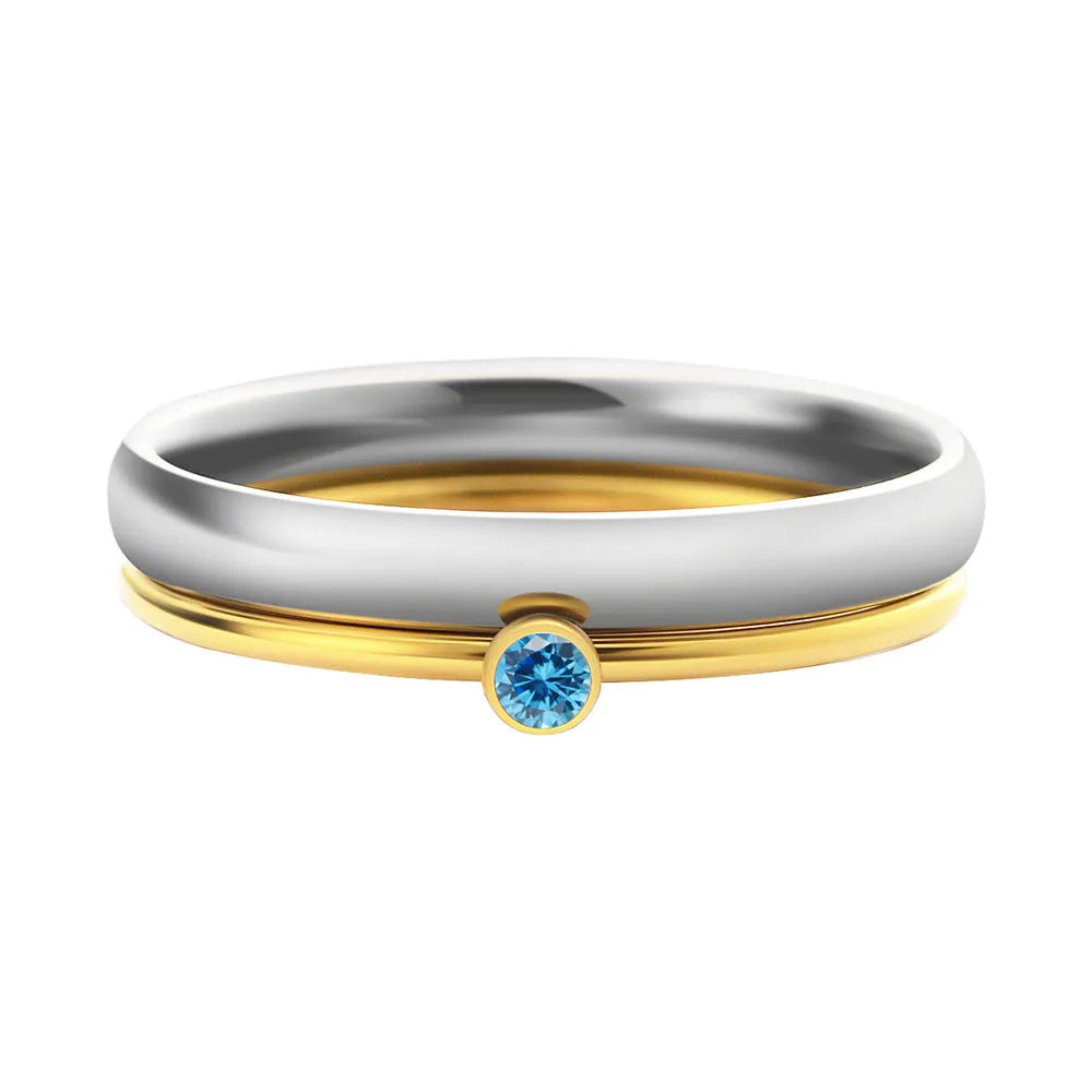 December birthstone geometric engraved ring in titanium steel on a grey background.