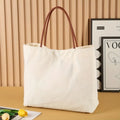 Beige white canvas tote bag with 40 litre capacity and double handles