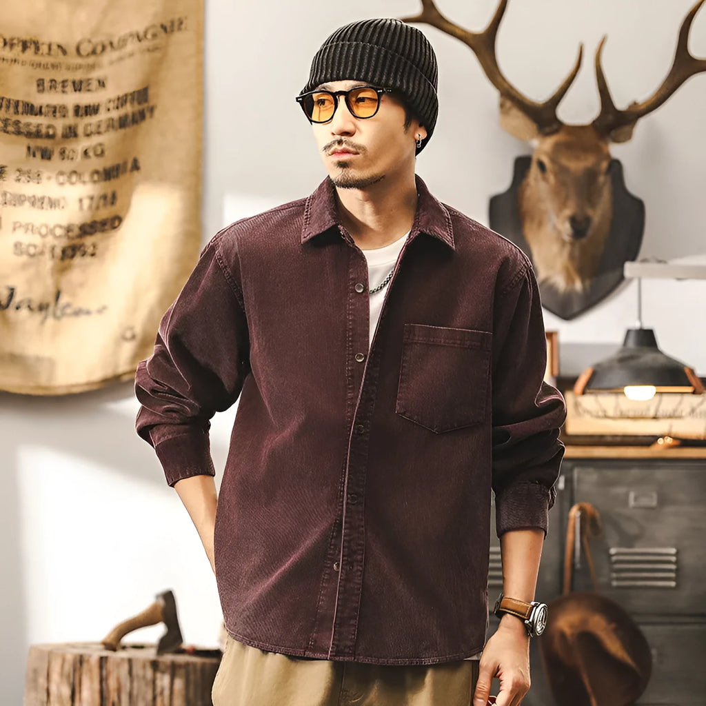 Men's black corduroy casual shirt jacket with long sleeves and a loose fit.