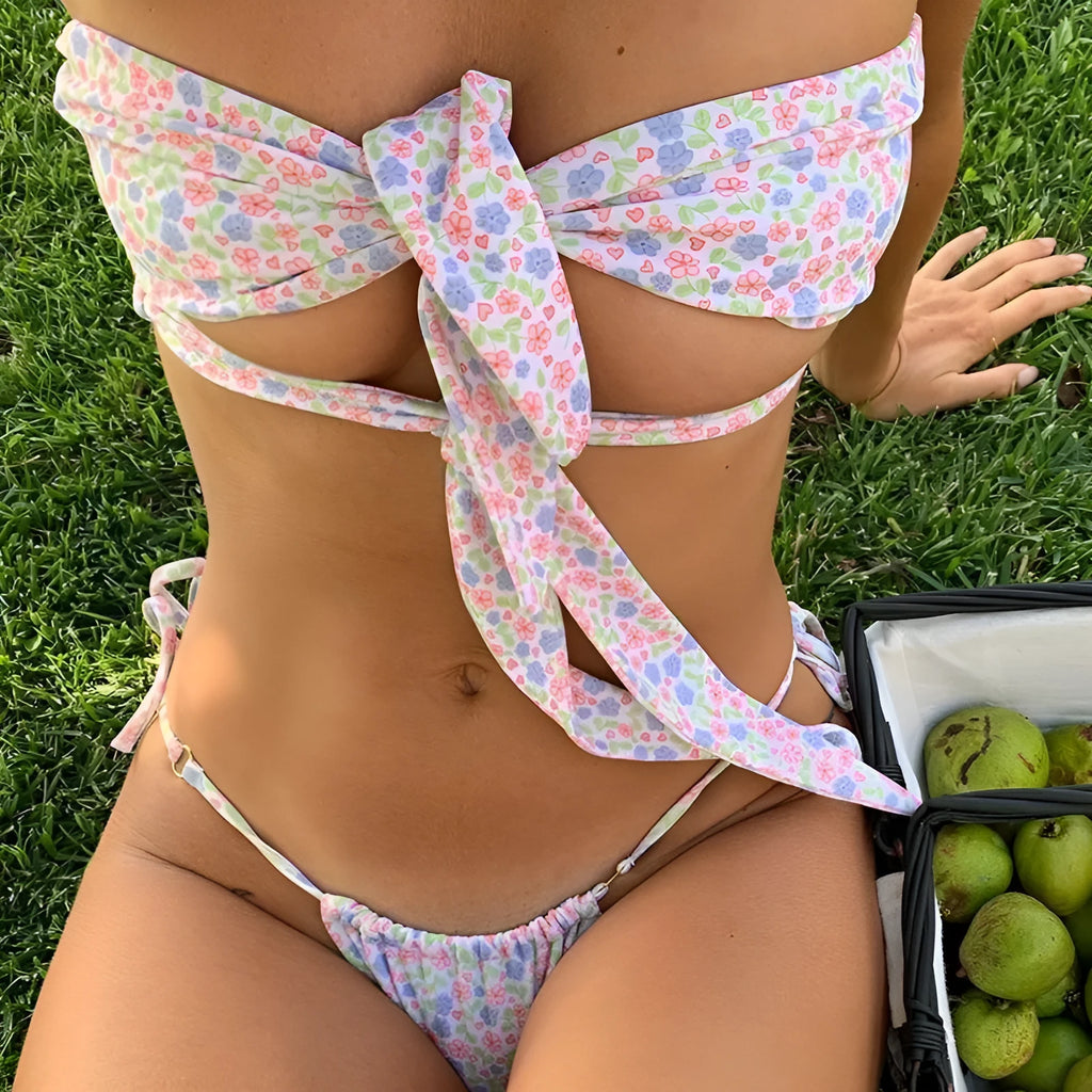 Women's one-piece lace-up front swimsuit with built-in chest pad in a floral print.