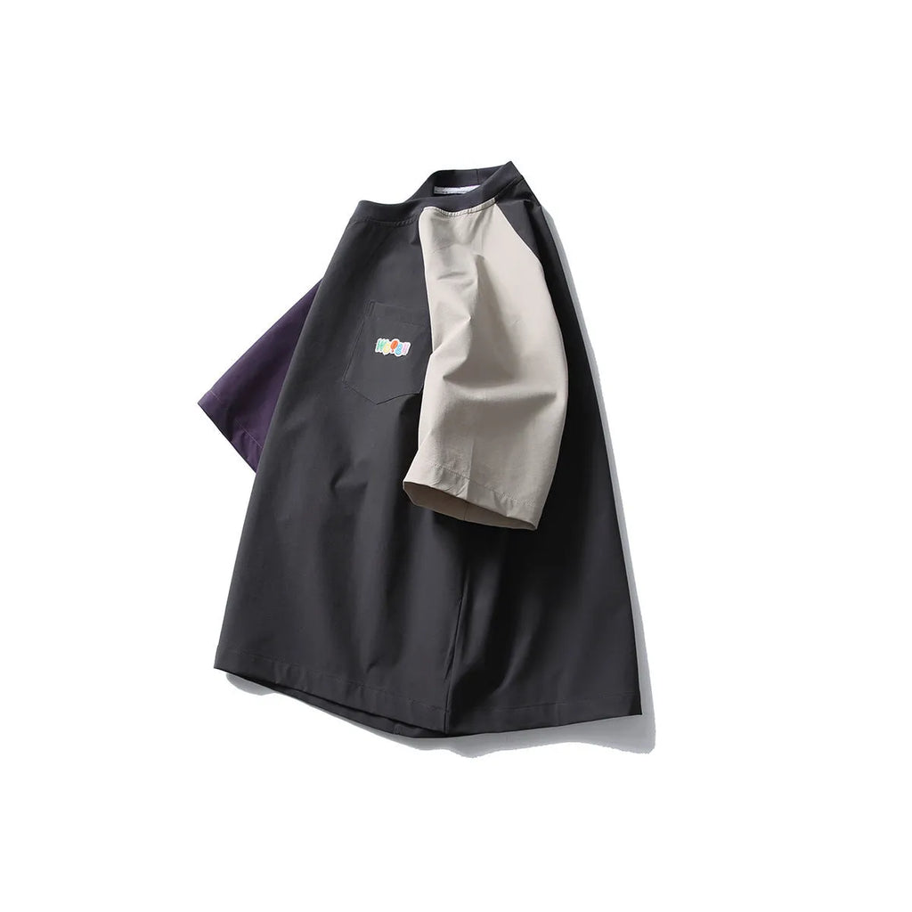 Dark grey men's loose fit T-shirt with contrast colour raglan sleeves on a hanger.