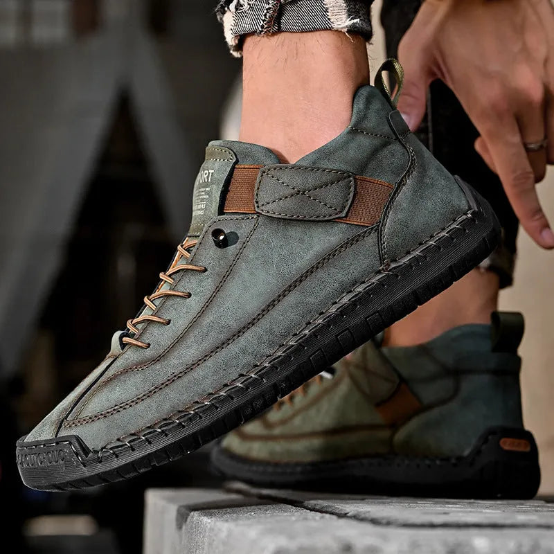 Men's mid-calf black Martin boot with stitching detail and elastic side band, flat rubber sole.
