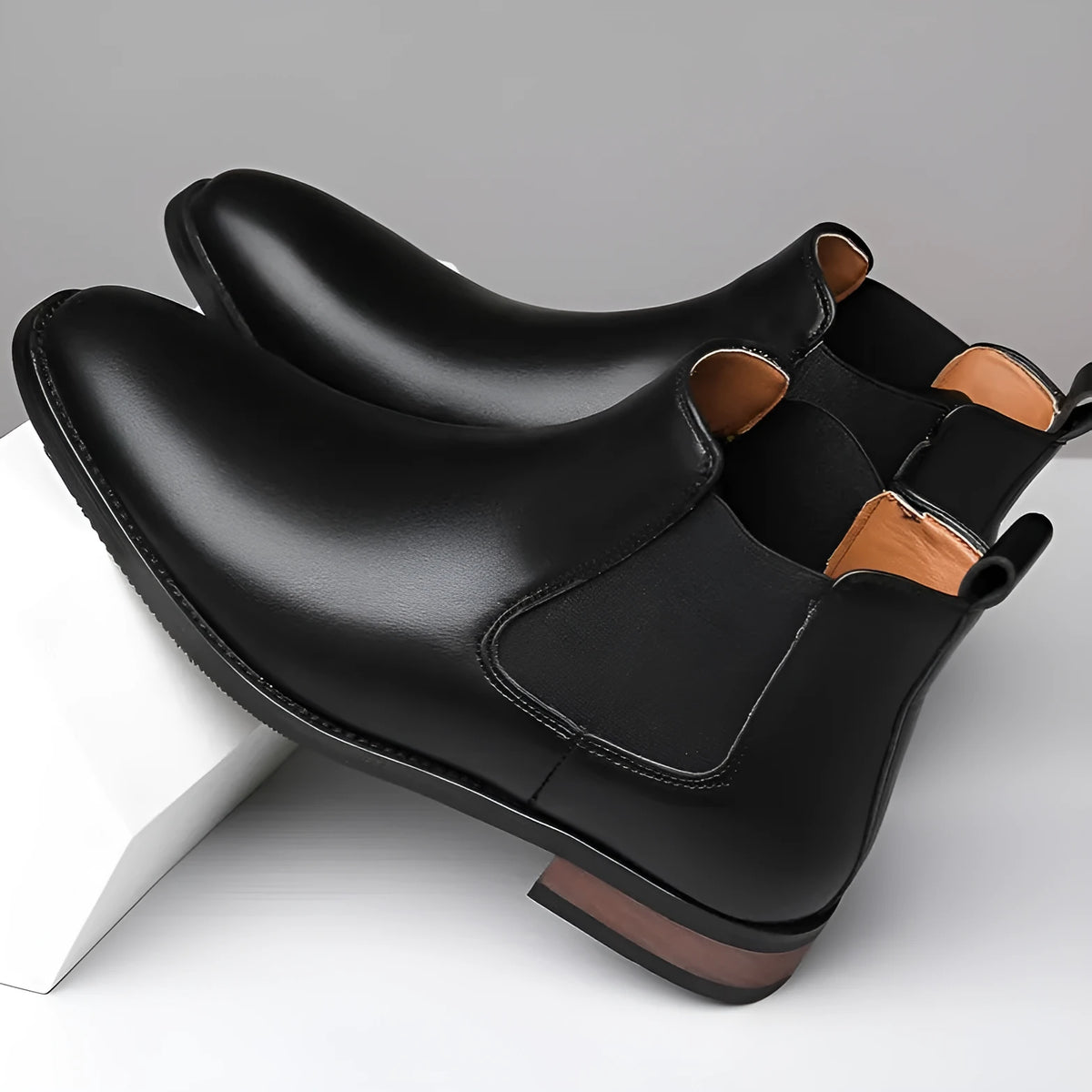 Men's black pointed Chelsea boots with low heel and rubber sole