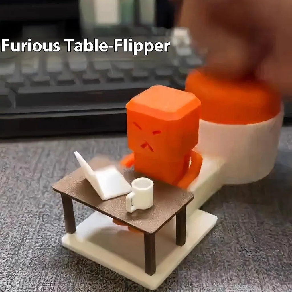 Orange plastic Take and Vent table-turning decompression toy on a desk