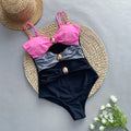 Women's brown one-piece swimsuit with a matching beige skirt laid flat.
