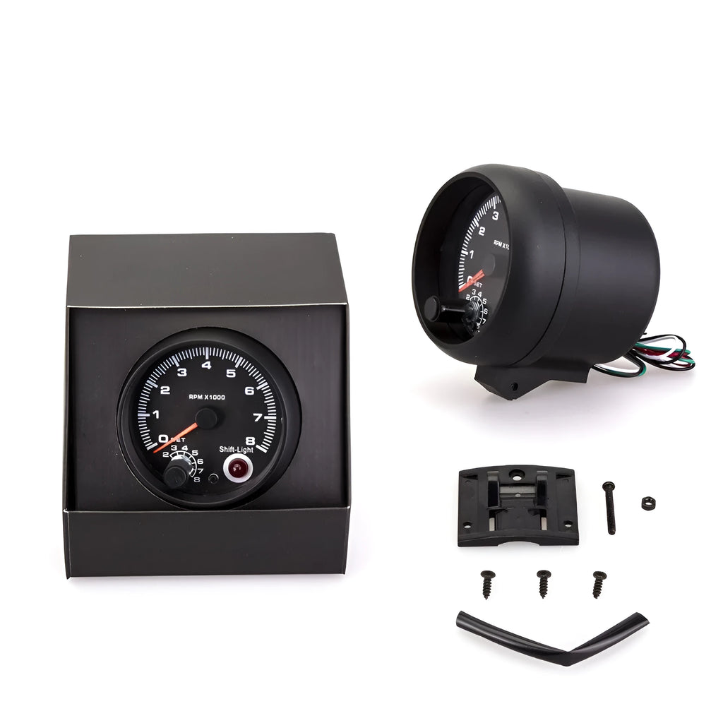 Black plastic automotive tachometer with blue light pointer display showing RPM scale