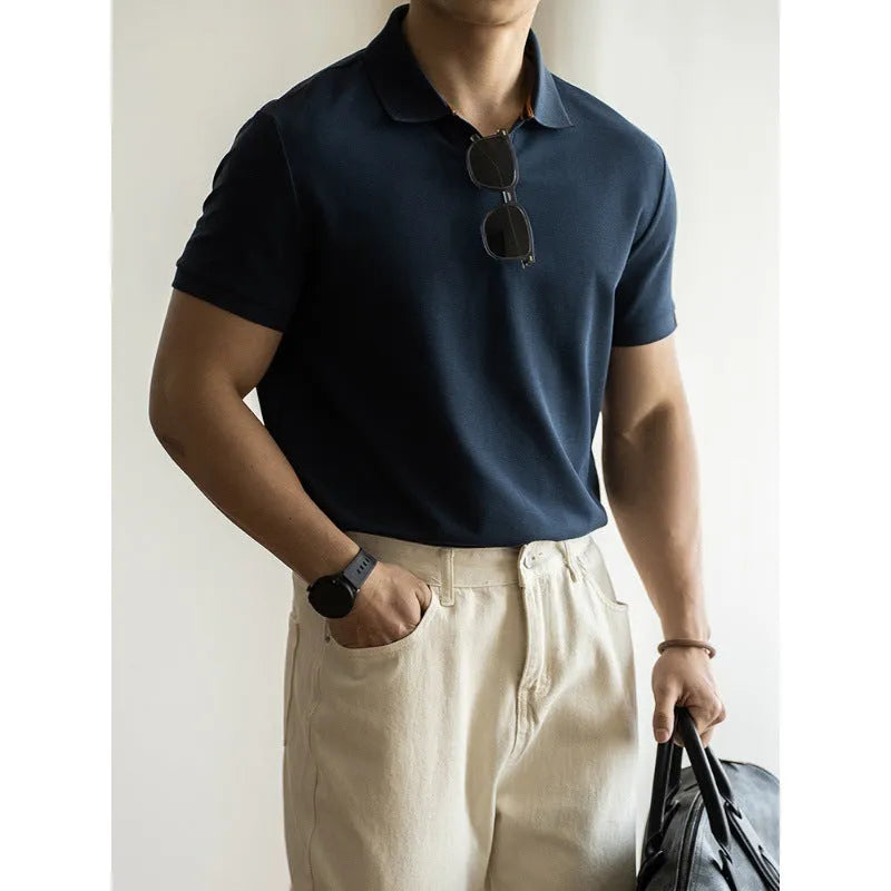 Man's American-style blue cotton blend short-sleeved polo shirt on a hanger.