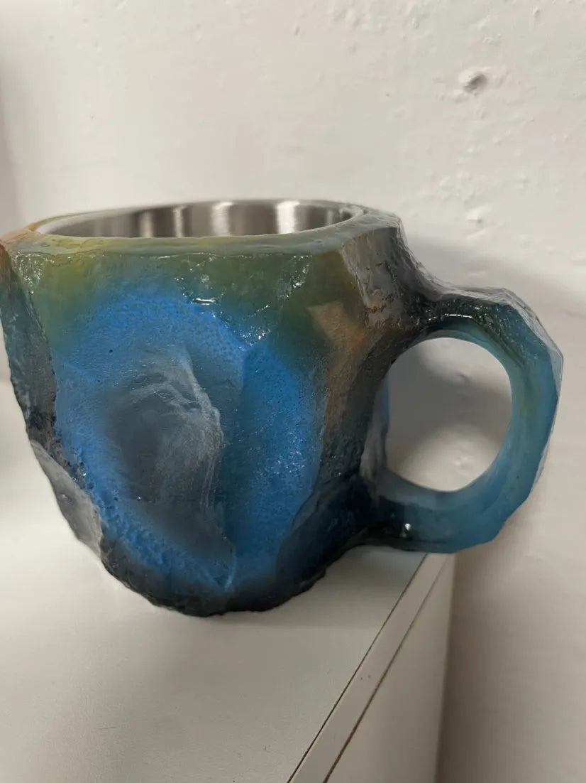 Resin mineral crystal coffee mug with handle in purple colour, showing 3D texture.