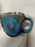 Resin mineral crystal coffee mug with handle in purple colour, showing 3D texture.