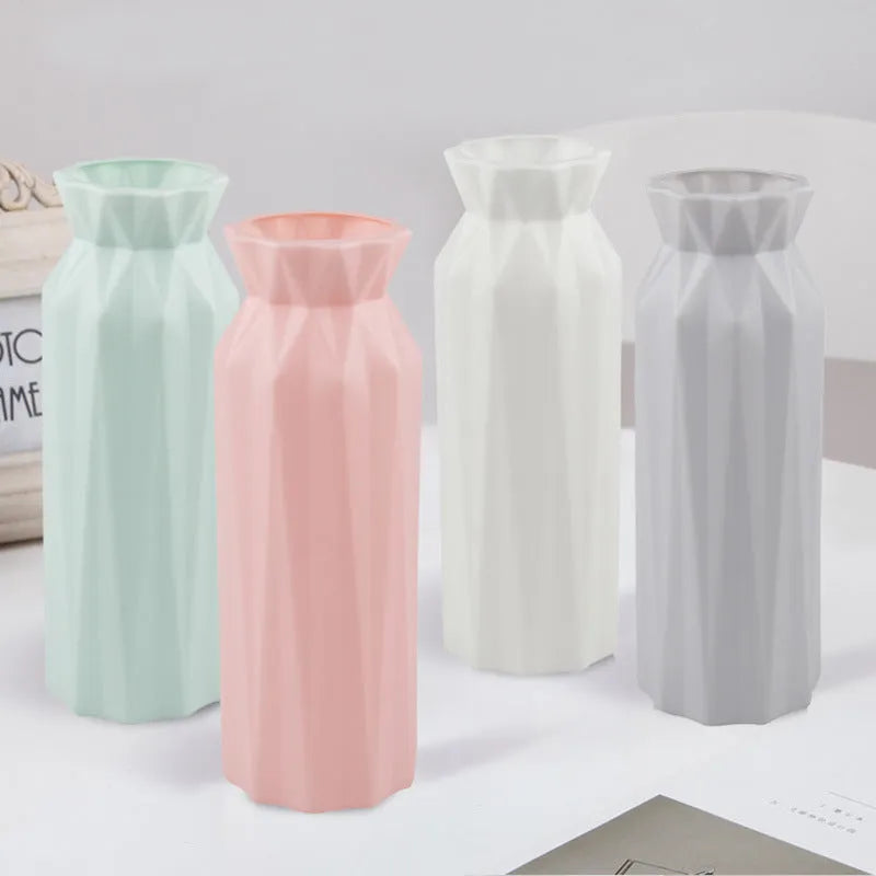 Simple green melamine plastic vase with a wide 7.2 cm base on a wooden table.