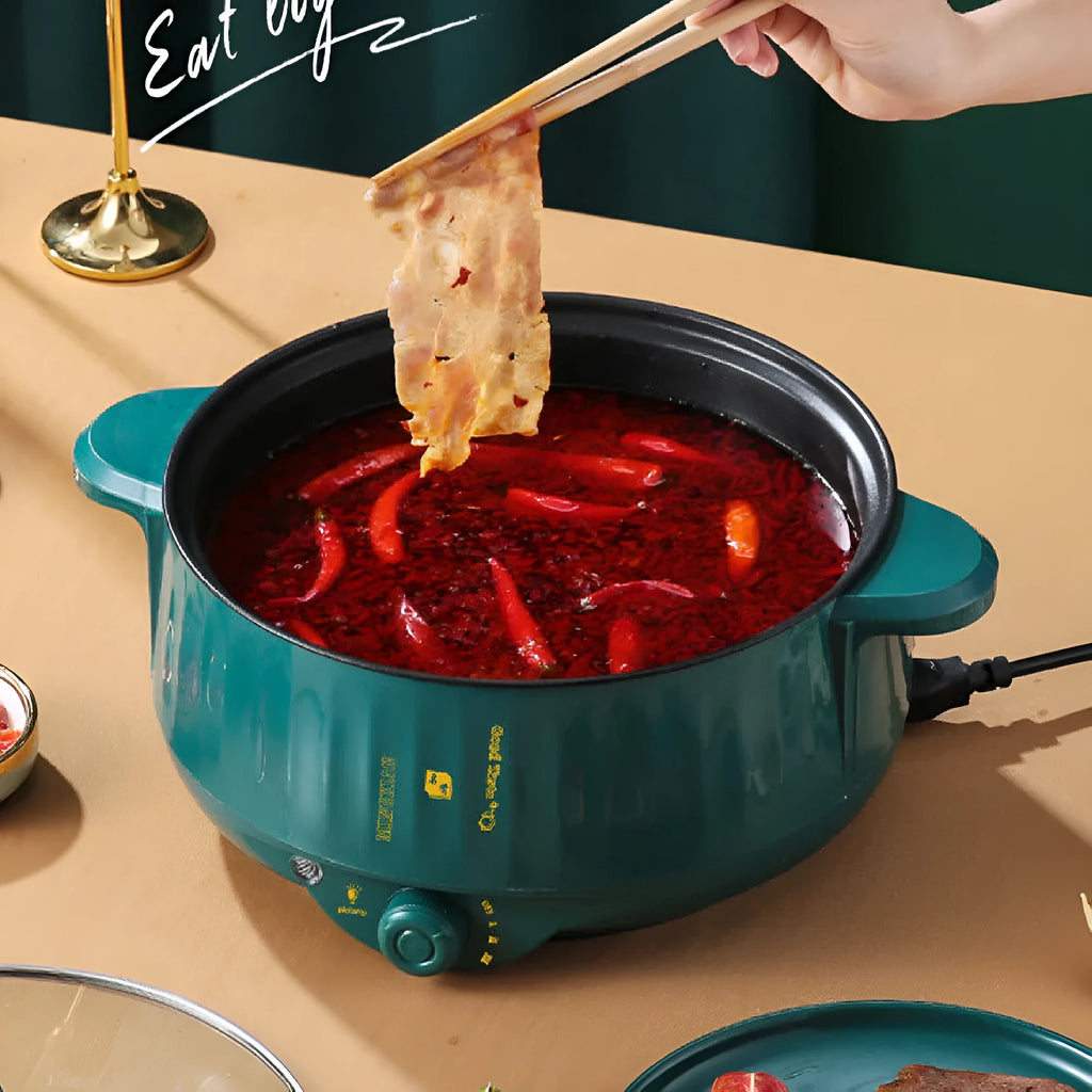 Stainless steel electric hot pot with non-stick coating and integrated heating base.