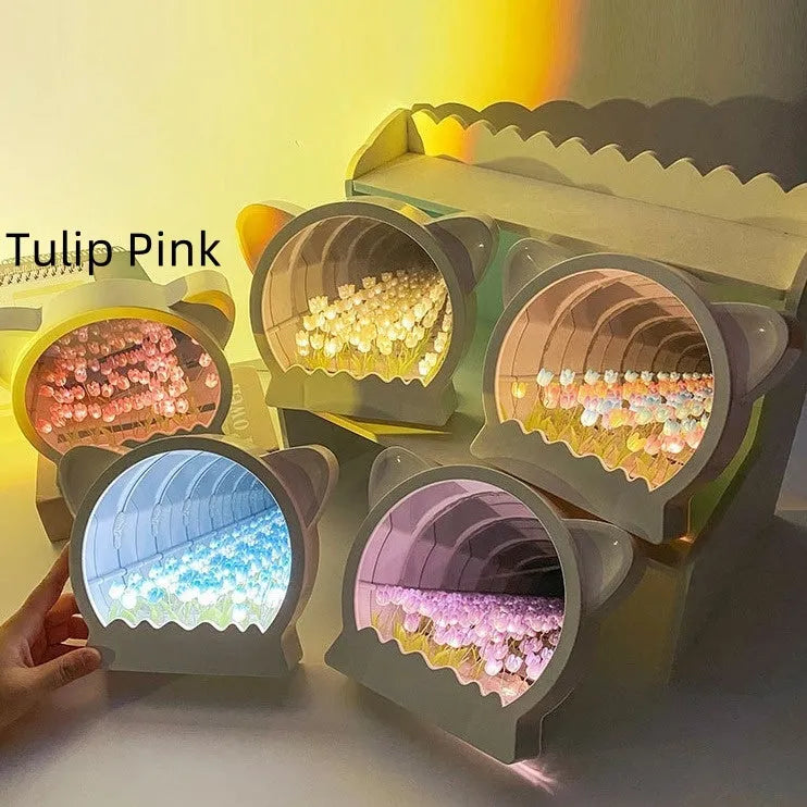DIY craft kit for a cat head night lamp surrounded by handmade pink, blue, and purple tulip flowers.