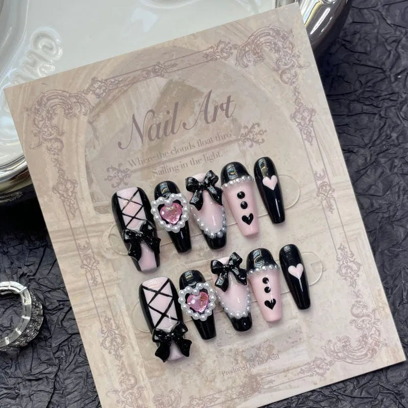 Black detachable manicure set with hand-painted pink hearts and bow patterns in cat eye style