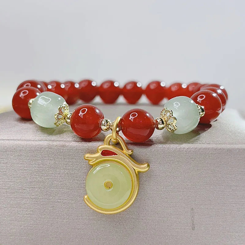 Women's red agate bracelet with Chinese dragon design, a handcrafted gift for Bamboo Festival.