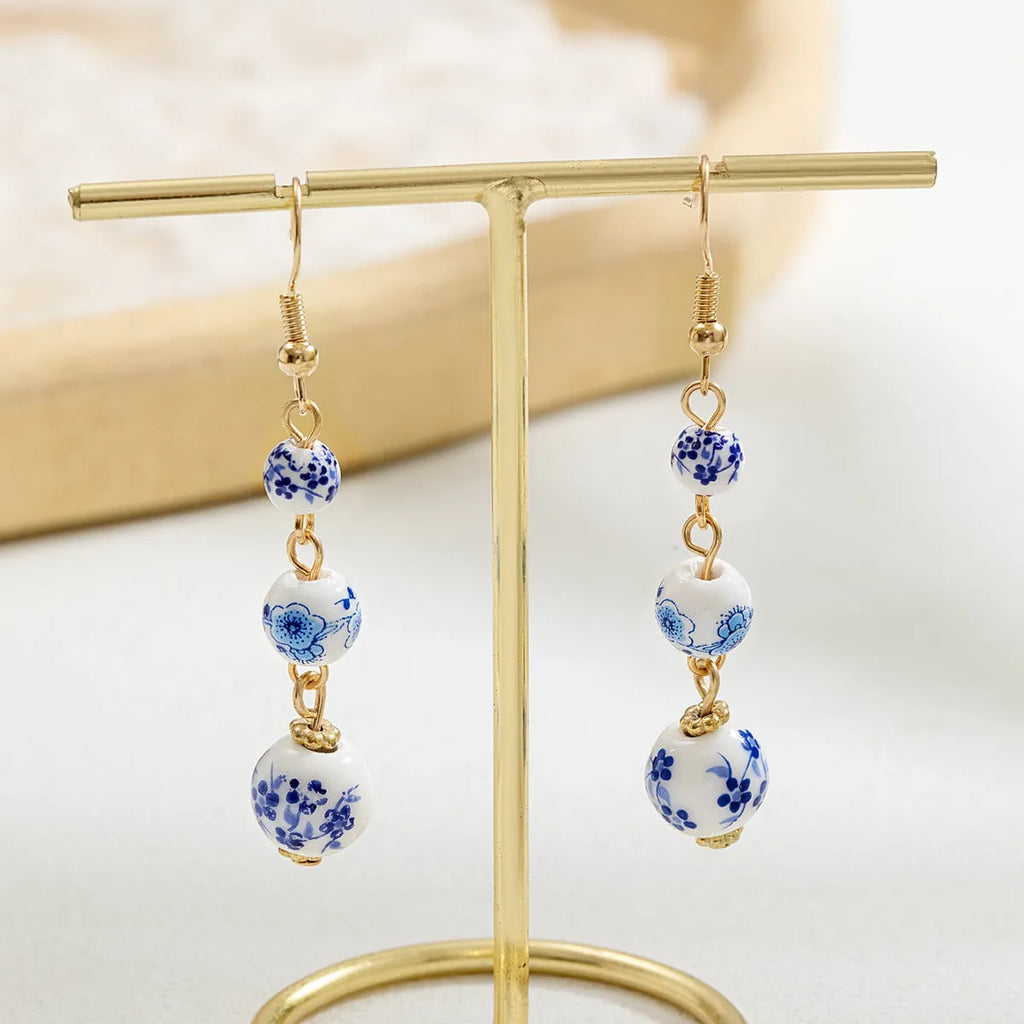 Blue and white porcelain ceramic bead retro earrings with geometric alloy electroplated construction