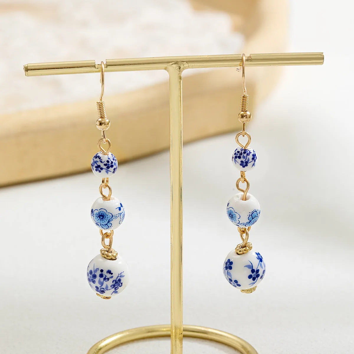 Blue and white porcelain ceramic bead retro earrings with geometric alloy electroplated construction