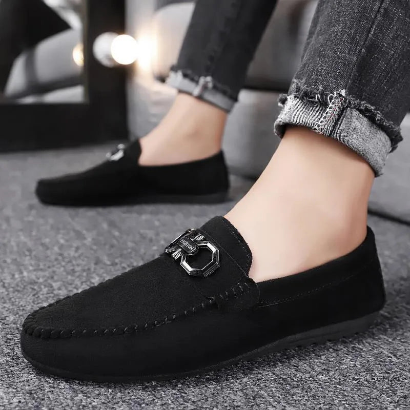 Men's black and grey suede and leather casual sneakers with rubber sole on a plain background.