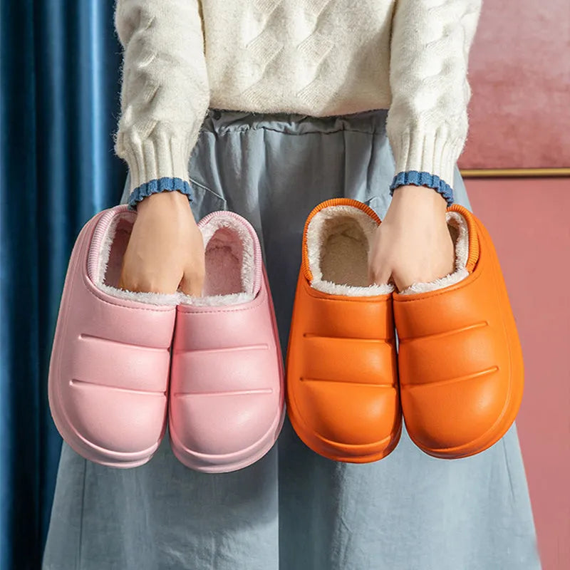 A pair of waterproof EVA couple slippers with a plush lining, shown in a choice of colours like green, pink, or grey.